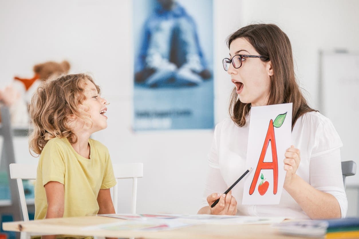 A speech pathologist working on speech sounds with a child